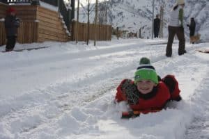 kid playing in the snow